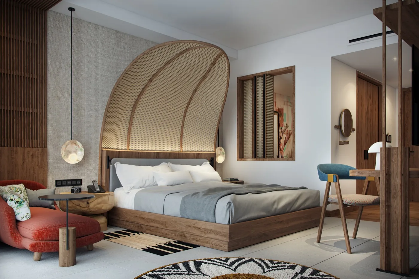 A guest room with a woven headboard and a balcony onto the bay